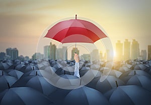 Businessman with red umbrella among others, unique different concept