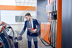 Businessman Refueling Car