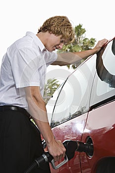 Businessman Refueling His Car