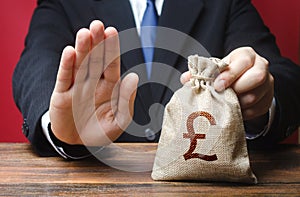 Businessman refuses to give pound sterling GBP money bag. Refusal to grant loan mortgage, bad credit history. Refuses cooperate. photo