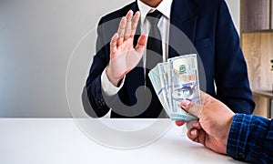 Businessman refusing money offered by his partner