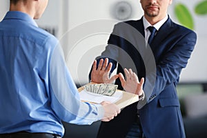 Businessman refusing to take bribe. Corruption concept