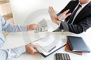 Businessman rejecting money or refusing money form of dollar bills to take the bribe to agreement contract, anti bribery and