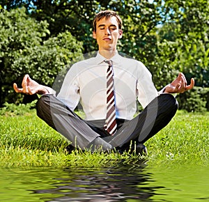 Businessman relaxing on the grassland