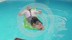 Businessman relaxing on lilo