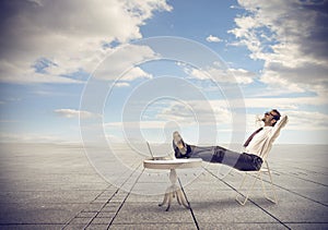 Businessman relaxing looking at the sky