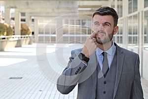 Businessman removing dried nasal secretions