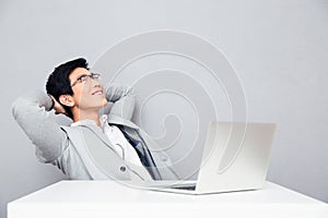 Businessman resting at the table with laptop