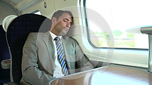 Businessman Resting On Train Journey