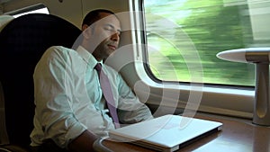 Businessman Resting On Train Journey