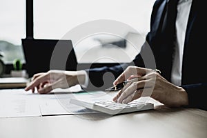 A businessman is reviewing information from finance documents to bring to department and partnership meetings, preparing monthly