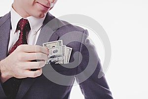 Businessman or rich guy pick money from suit pocket with smiley face. Millionaire person can earn a lots of money, making a lot of photo