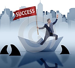 Businessman riding paper boat ship in success concept