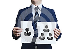 Businessman ripped a piece of paper as a symbol of disagreement in the team. Dismissing one team member. Businessman removes /