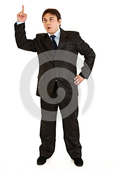 Businessman with rised finger. Idea gesture photo