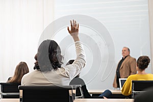 Businessman rises hand up for the question in the diverse employees business people team group. The colleagues discussing and