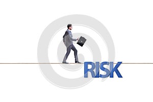 The businessman in risk concept walking on tight rope