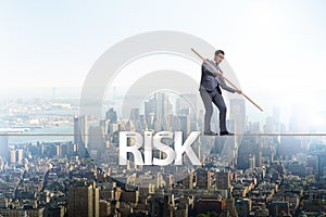 The businessman in risk concept walking on tight rope