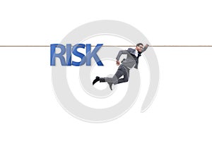 The businessman in risk concept walking on tight rope