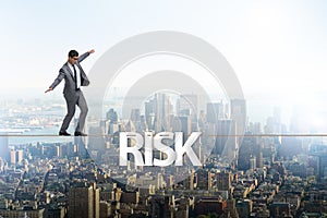 The businessman in risk concept walking on tight rope