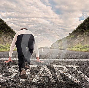 Businessman on a road ready to run