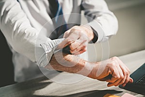 Businessman rolling up his sleeves