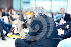 Businessman at round table, business conference, corporate presentation, workshop, coaching training or company meeting