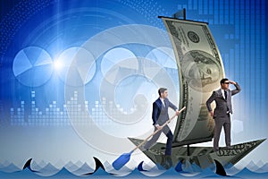 The businessman rowing on dollar boat in business financial concept