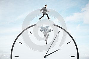 Businessman runing on gear cogwheel clock