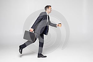 Businessman running with a briefcase isolated over white background