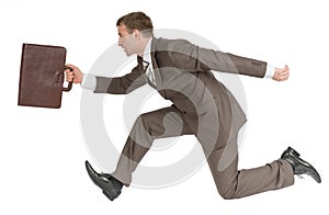 Businessman running fast with suitcase