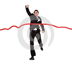 Businessman running through finishing line