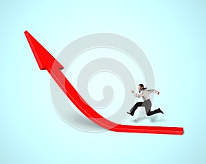 Businessman running on growing red arrow