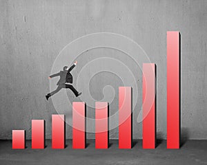 Businessman running and jumping on red bar chart