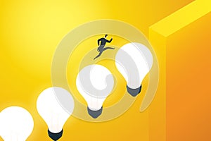 Businessman running on a light bulb up the cliff