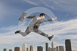 Businessman Running Midair Above City