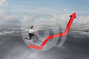 Businessman running on red growth trend line