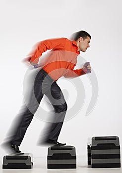 Businessman running up with dumbbells