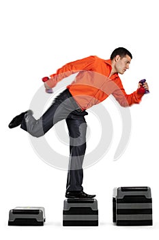 Businessman running up with dumbbells