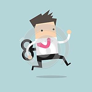 Businessman running with wind-up key