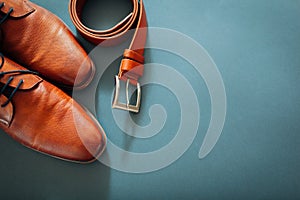 Businessman`s accessories. Brown leather shoes, belt, perfume, golden rings. Male fashion. Businessman