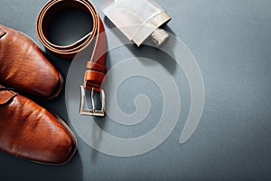 Businessman`s accessories. Brown leather shoes, belt, perfume, golden rings. Male fashion. Businessman