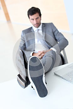 Businessman's feet on table