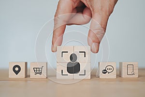 businessman`s hand complete  crop icon, people inside  on wood cube   for Buyer persona and target customer concept. Buyer