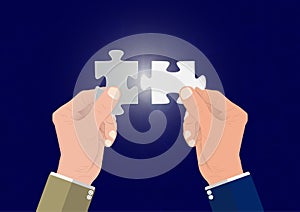 Businessman`s hand connecting two puzzle pieces jigsaw together,successful solution business concept