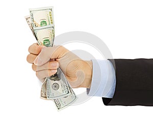 Businessman's hand grasping a handful of dollars photo