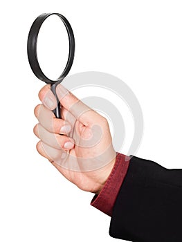 Businessman's hand holding magnifying glass