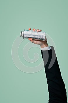 Businessman's hand holding spray can on isolated background. Quaint