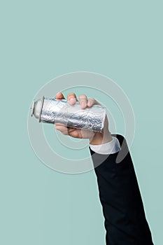 Businessman's hand holding spray can on isolated background. Quaint