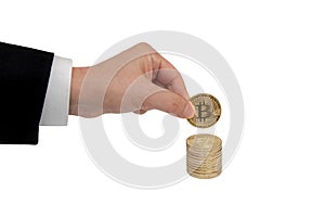Businessman`s hand holds a gold coin bitcoin coin. Isolated on white background.